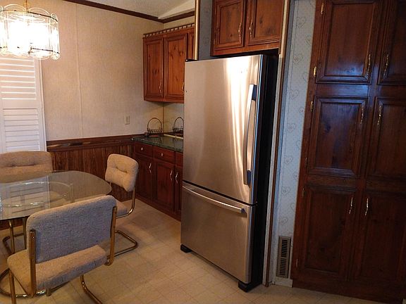 Stainless finish appliances: smooth top stove, dishwasher, and refrigerator. Dining table included.
