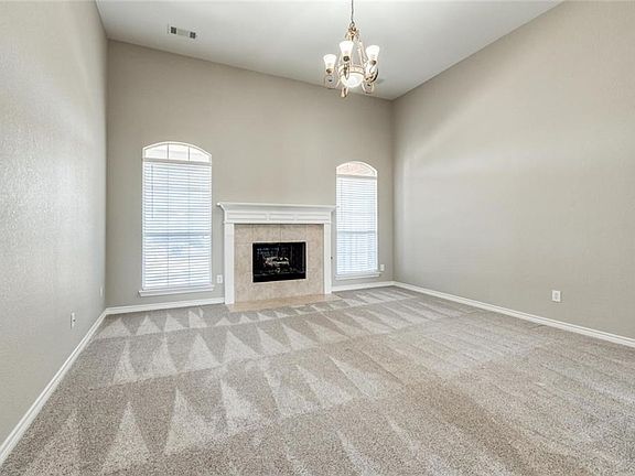 Formal living room has gas log fireplace, brand new carpet, fresh paint.