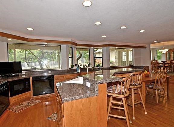 A glorious, open planned kitchen is the hub of the home with a wall of picture windows providing you