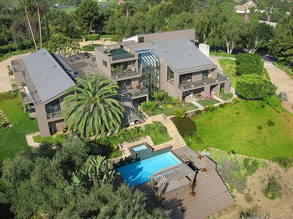 Frank Lloyd Wright inspired & architecturally detailed home w/ tropical garden