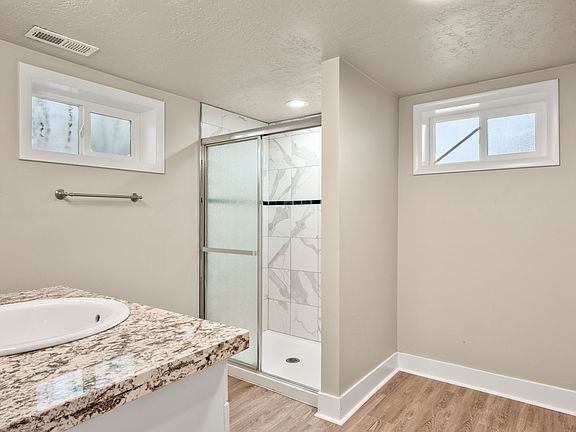 Featuring walk in shower and plenty of natural light from windows.
