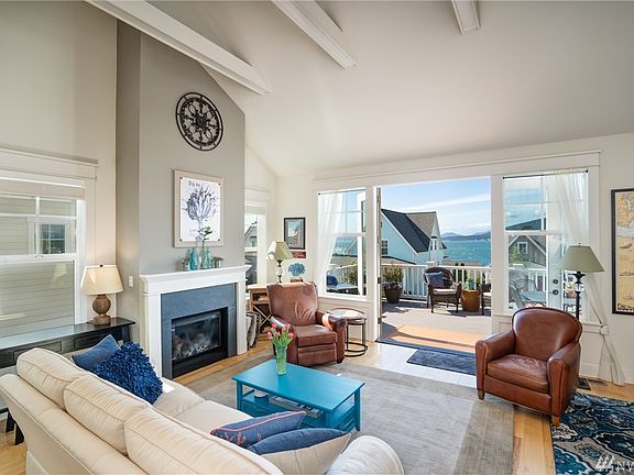 French doors lead from the living room to an expansive rear deck with water views.