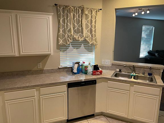 Kitchen Sink and Dishwasher overlooking open Living Dining Room
