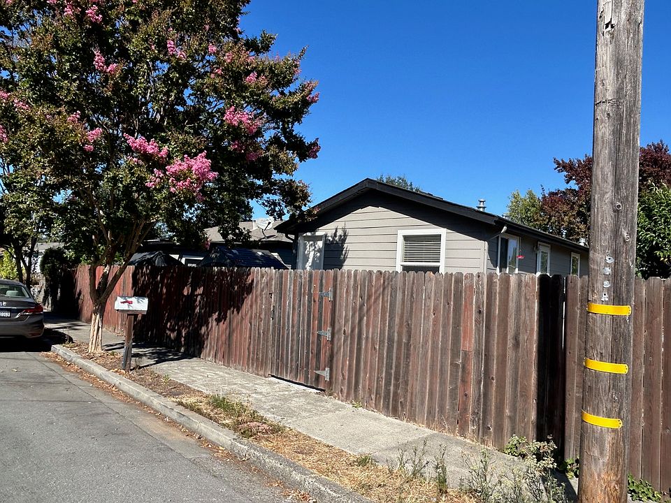 Front of home behind 6 ft fence.