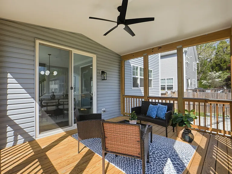 Beautiful backyard with large screened in porch, planter boxes, a grill pad, and a fire pit, ready to host your next family gathering!