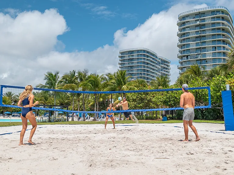 Gather with friends for a game of beach volleyball beside the crystal lagoon.