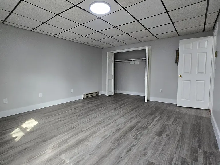 very large bedroom with closet and access to outside rear courtyard
