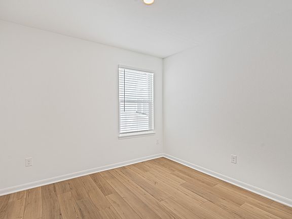Secondary bedroom with vinyl flooring