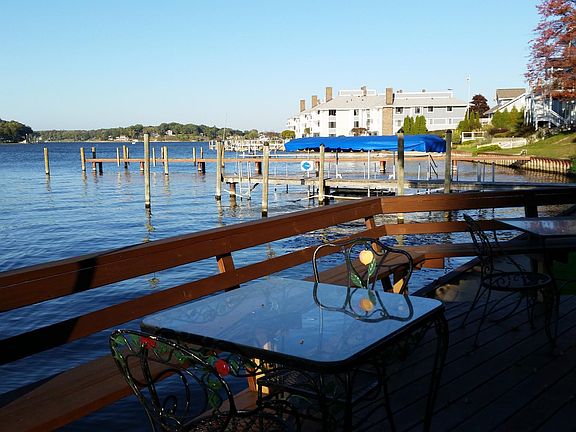 There are several tables and chairs on the deck.