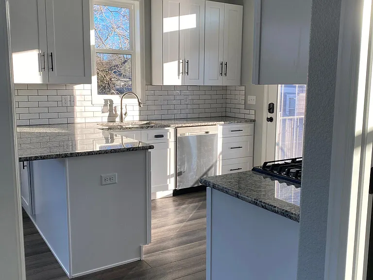 Backsplash compliments beautiful granite countertops. Multiple ceiling lights brighten up the apartment at night. This apartment has everything you need; beautiful finishes and bright light day or night.
