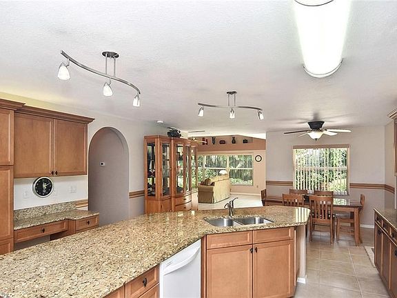 Large, open kitchen features counter height island with room for bar stools.