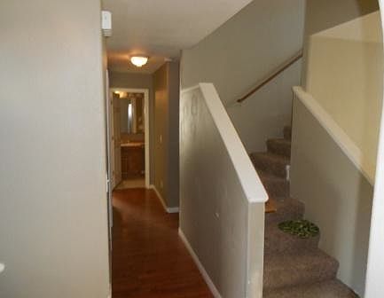 Hallway to three downstairs rooms and upstairs great room