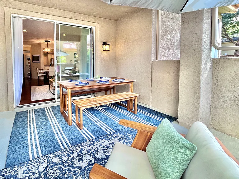 Step directly from the living room into the stylish outdoor dining area for six, offering an elegant space to savor meals and create memorable moments.