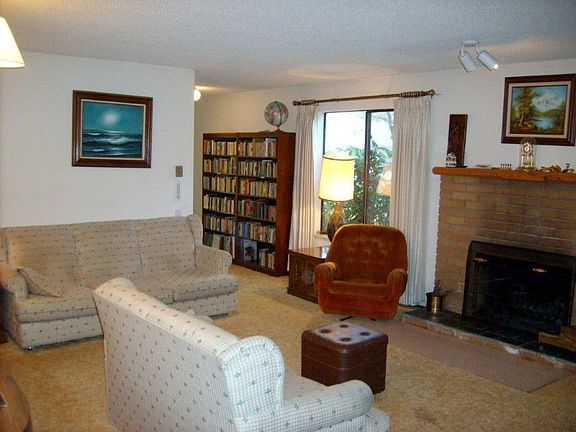 Cozy up to the wood burning brick fireplace in this room which offers many options for furniture arr