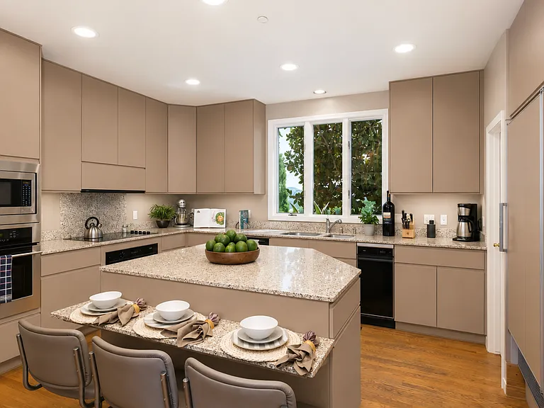 Bright functional kitchen with abundant cabinetry, generous counter space, and a large center island. Designed for everyday living and entertaining, it flows seamlessly into the dining and living areas while capturing the home's warm, inviting atmosphere.