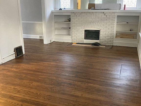 living room with hardwood floors and decorative fireplace