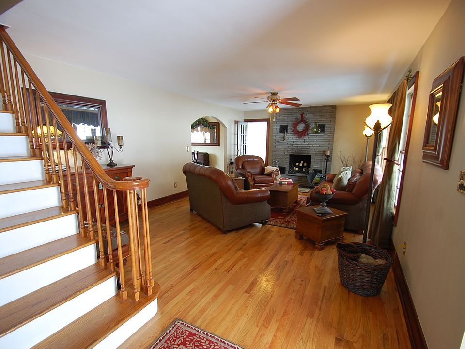 Living Room - hardwood floor, stone fireplace, ceiling fan with light