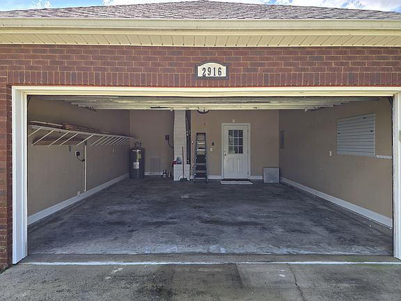 2 car garage with little nook in the far back left; fits a small riding lawn mower