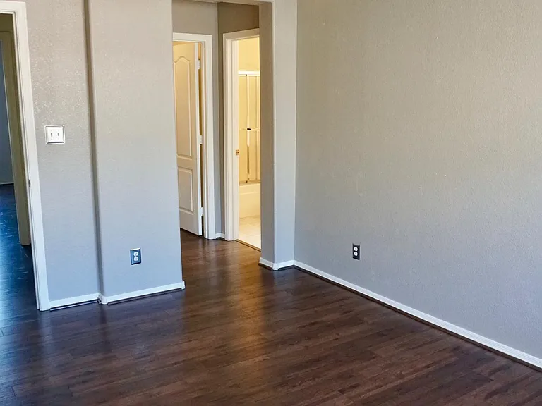 Secondary bedroom has ensuite bathroom (new shower/tub combo in July 2026!), walk in closet and new ceiling fan (old fan in picture).