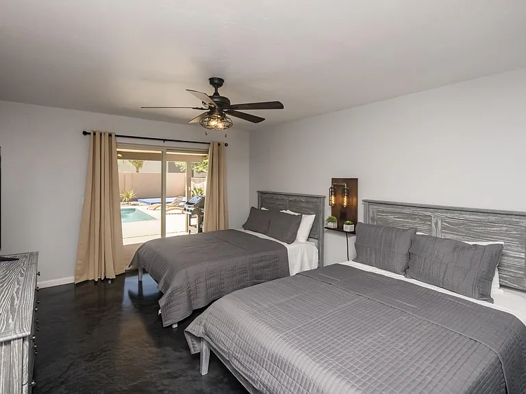 Master bedroom offering abundant natural light and direct outdoor access to pool and patio.