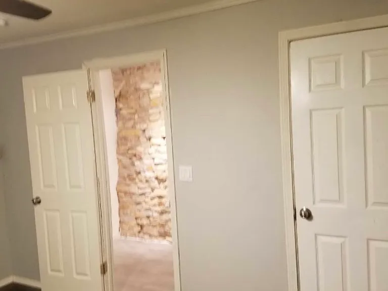Hallway from master bedroom to side entryway 2 and kitchen