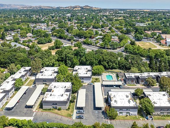 A bird's eye view of a suburban area with a large building complex in the foreground.