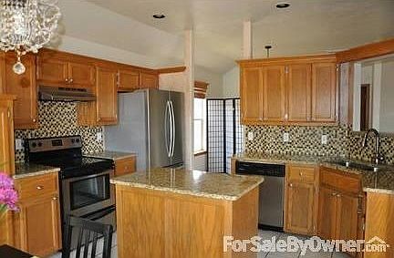 Kitchen with Stainless Appliances
						:
						Island, stainless appliances, updated granite counters,
