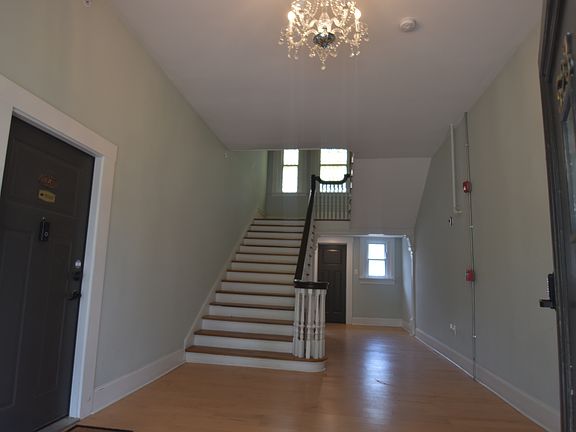 Large foyer with maple floor, crystal chandelier, and beautiful stairway greets you, once you enter the building using your secure code