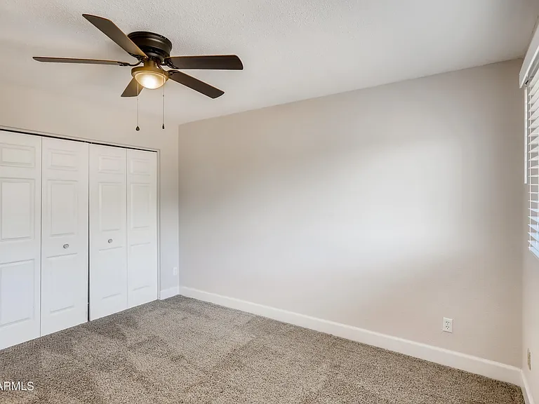 Bedroom 2 is a spacious carpeted room featuring a large closet & great views of the large corner lot front yard.