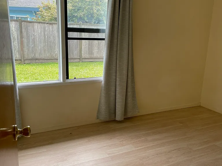 Sunny Bedroom 2 with Window Coverings and Laminate Flooring