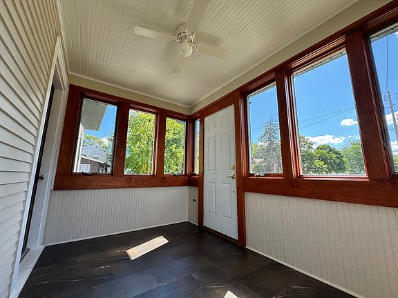 Enclosed sunporch with wrap around windows & ceiling fan for months of enjoyment