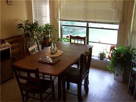 Breakfast area joins kitchen with view of backyard