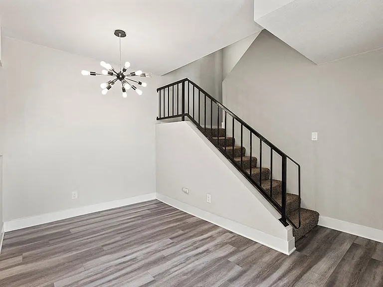 Living room with hardwood floor, fireplace, and Edison lighting.
