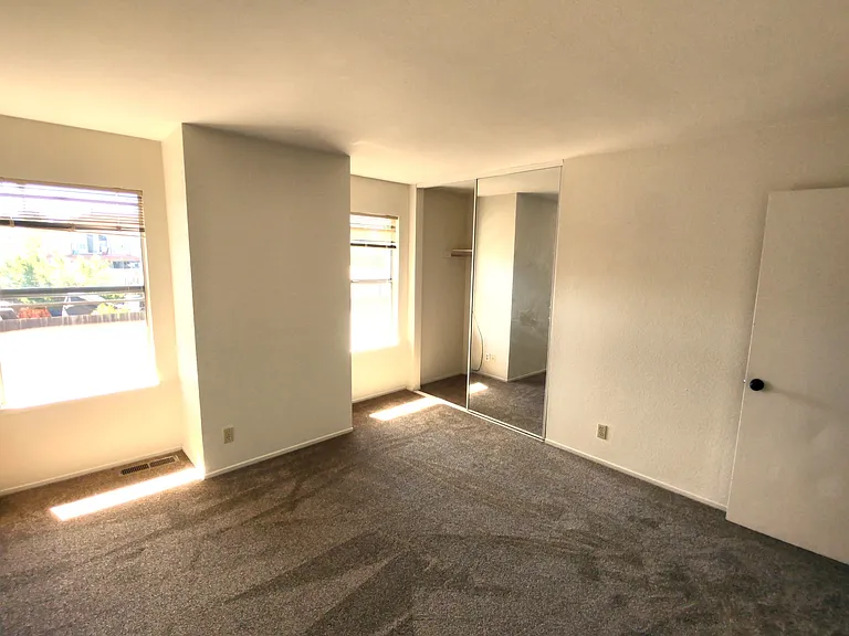 2nd bedroom, as seen from the corner, facing the closet. Door to hallway is up right.