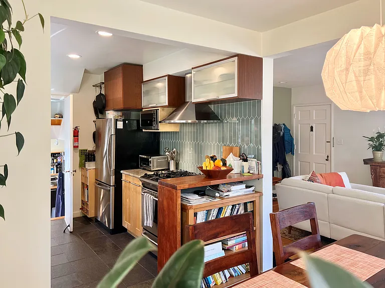 View of Kitchen and Living room from dining table; Bonus room beyond kitchen