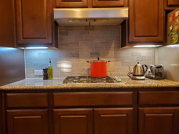 Kitchen is equipped with stainless steel apppliances and gas range