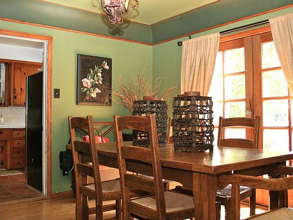 DIning room with French doors opening to brick laid patio