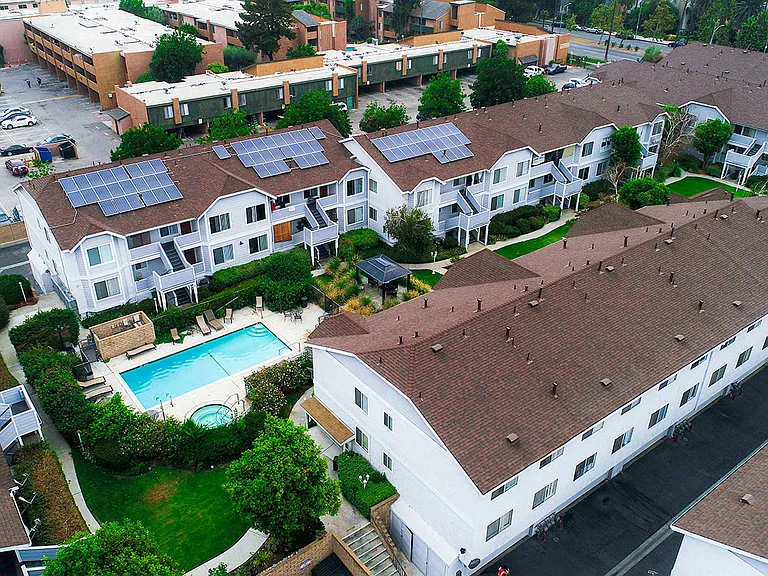 Aerial drone view of roof showcasing solar panels for a low carbon footprint.
