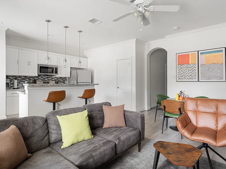 Living area flows seamlessly into the kitchen and front entry.