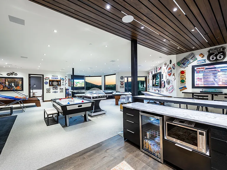 Game room Kitchenette with microwave, mini fridge and sink. 
ALSO a powder bath is right here for use in the game room