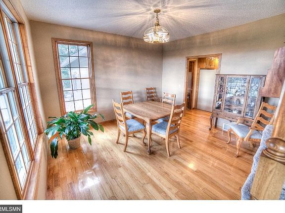 Roomy dining room conveniently situated next to kitchen boasts many windows for a great view of the park-like property.