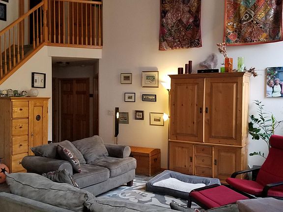 Great room with vaulted ceiling and gas fire place. Stairs lead to 3 upstairs bedrooms and full bathroom