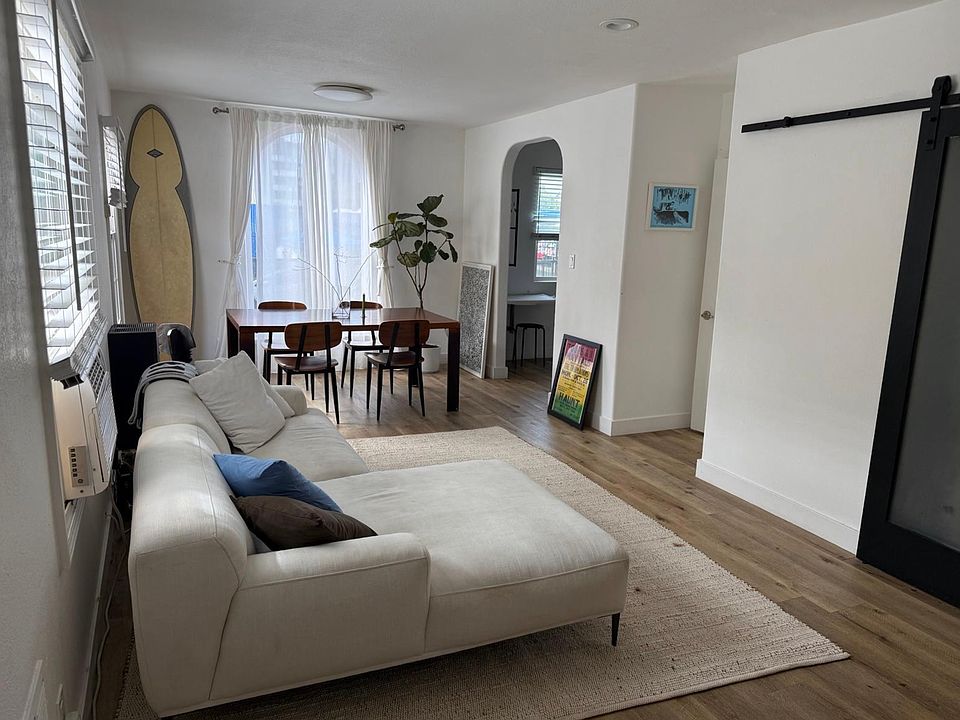 Open plan space with modern barn door that go to the bedroom.