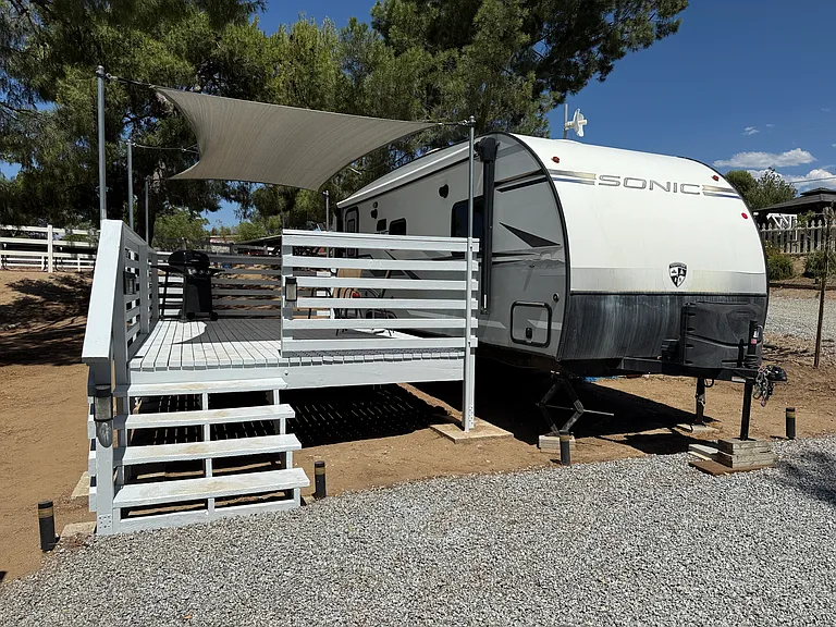 Large 10' x 18' deck covered by tightly secured tarpalin.