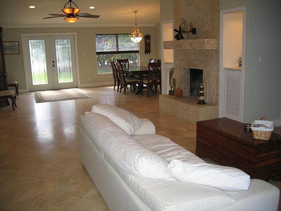 Great Room with Coral, wood burning fireplace. Entire home has travertine flrs