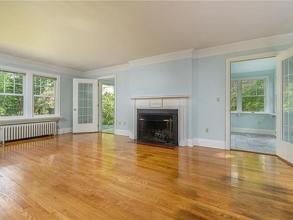 The Living Room is spacious with a wood burning fireplace.