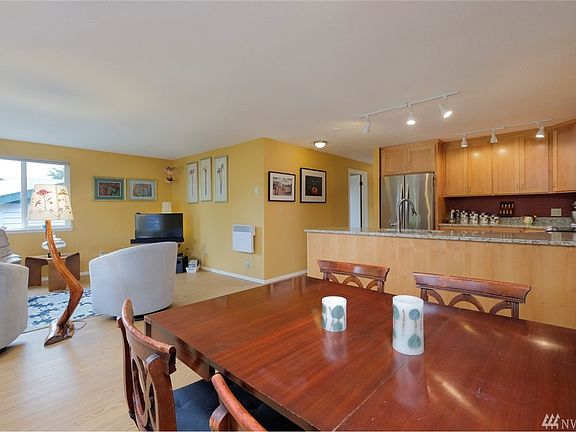 Another view of the living / dining areas.  Interior and exterior paint & all new flooring and trim (no carpet) are just a few of the enormous list of enhancements made to the home.  