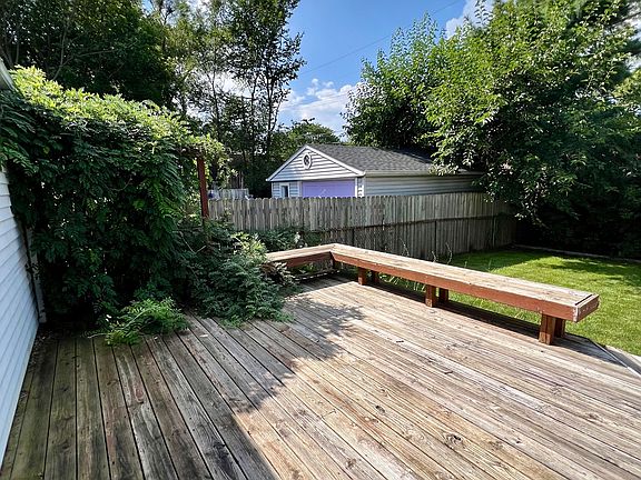 Fenced backyard with deck