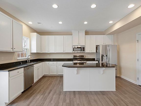 Gourmet Kitchen with upgraded cabinetry, granite counter top and stainless still appliances.