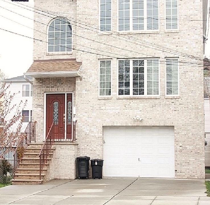 Building front, 2 off-street parking, and a drive-in garage